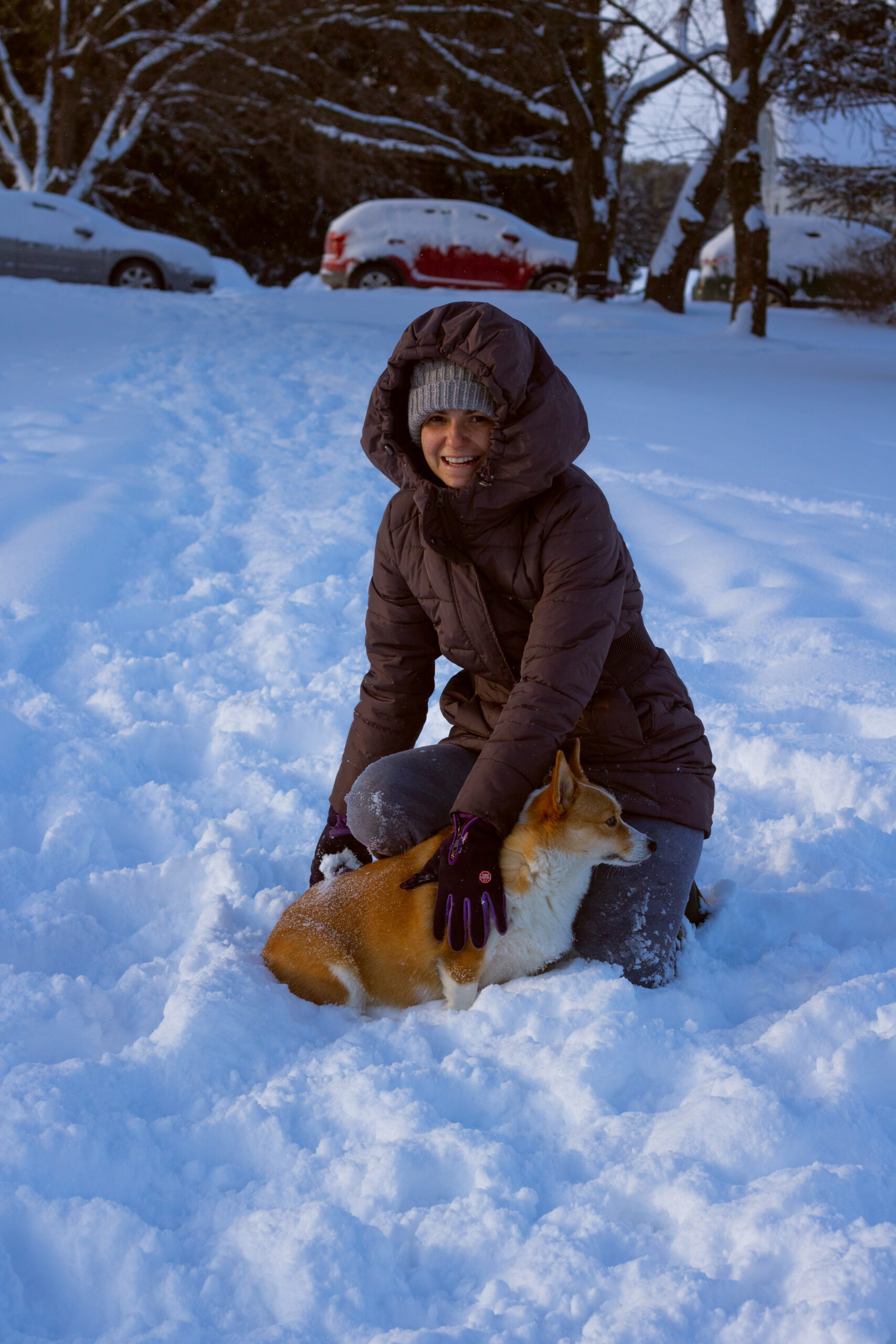 Woman posing with her corgi during a winter photoshoot